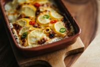 Kaboompics - Fish Casserole on Wooden Board with Lemon Slices