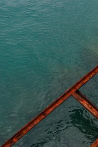 Kaboompics - Close-Up Teal Seawater with Rusted Metal Railing