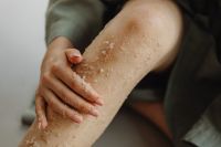 Kaboompics - Close-Up of Hand Massaging Sea Salt Scrub onto a Bare Leg