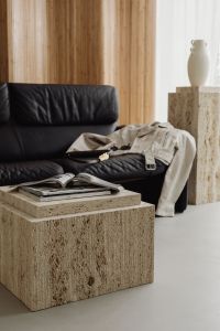 Kaboompics - Warm Japandi Living Room with Black Leather Sofa and Travertine Tables