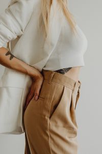Kaboompics - Minimal Fashion Woman in White Shirt and Beige Trousers Side View