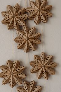 Kaboompics - Wooden Snowflake Ornaments Hanging on Wall