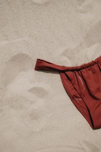 Kaboompics - Close-Up of Red Bikini Bottom on Sandy Beach