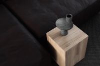 Kaboompics - Gray Sculptural Vase on a Wooden Cube Table Beside Black Leather Sofa, Overhead View