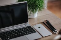 Kaboompics - Silver Acer laptop on a wooden desk with a green plant, pencils and an Apple iPhone