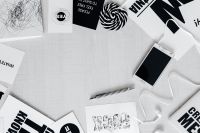 Kaboompics - Top View of Black and White Typography Cards with Phone and Earphones
