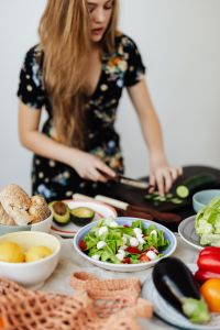 Kaboompics - Fresh Salad Bowl with Cucumber Slices and Bread during Kitchen Prep