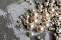 Kaboompics - Pearl Beads Scattered on Gray Concrete with Copy Space, Horizontal Jewelry Background
