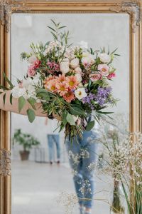 Kaboompics - Mixed Flower Bouquet Reflected in an Ornate Gold Mirror, Bright Floral Scene