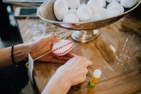 Kaboompics - Hands Decorating White Easter Eggs with Red Gem Stickers