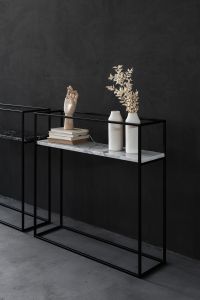 Kaboompics - Minimal Black Marble Console Styling with Sculptural Hand, Books and Ceramic Vases