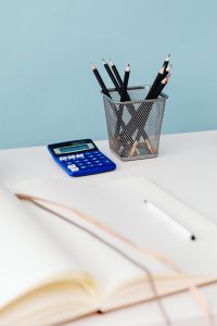 Kaboompics - Blue Calculator and Pencil Cup Beside an Open Notebook