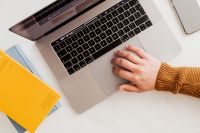 Kaboompics - Man works on a computer at his desk, mobile phone