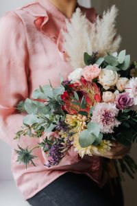 Kaboompics - Cropped View of a Woman Holding a Bouquet with Pampas Grass