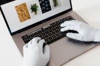 Kaboompics - Protective Gloved Hands Shopping Online on Laptop
