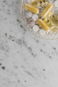Kaboompics - Golden Capsules in a Crystal Bowl with Copy Space