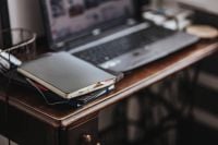 Kaboompics - Workplace with a laptop and a notebook on a desk