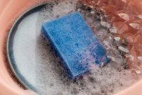 Kaboompics - Blue Cleaning Sponge in a Bowl of Soapy Water