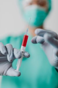 Kaboompics - Gloved Doctor Filling Syringe From Vial