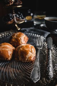 Kaboompics - Sweet Buns with Coffee and Silver Cutlery, Dark Food Styling