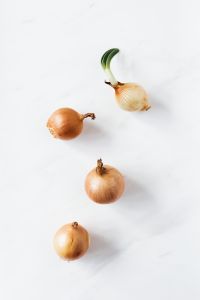 Kaboompics - Two Yellow Onions, One Sprouting, for Recipe and Ingredient Photography