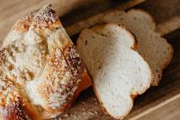 Kaboompics - Sliced Challah Loaf on Rustic Wooden Board