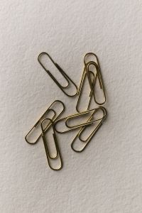 Kaboompics - Gold Paper Clips on White Background