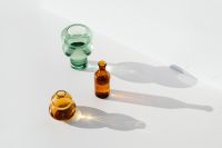 Kaboompics - Empty Green and Amber Glass Vases with Elongated Shadows on White