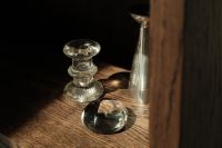 Kaboompics - Glass Sphere and Candle Holder on a Sunlit Dark Wood Shelf