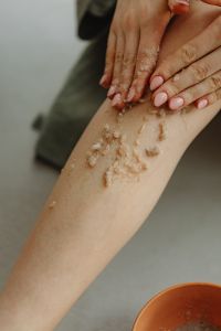 Kaboompics - Exfoliating a Leg with Sea Salt Body Scrub in an At-Home Spa
