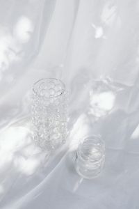 Kaboompics - Overhead Empty Glass Vases on a White Textile Backdrop