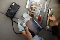 Kaboompics - Sorting Printed Travel Photos Outdoors