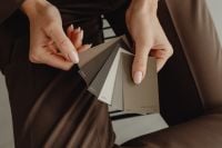 Kaboompics - Hands Comparing Earthy Paint Colors for Interior Aesthetic