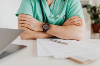 Kaboompics - Doctor Sitting With Folded Arms at Desk