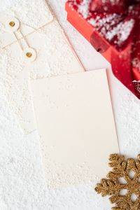 Kaboompics - Overhead Blank Christmas Card with Red Present and Gold Snowflake Accent