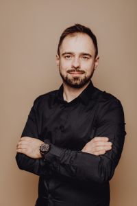 Kaboompics - Serious Man in Black Shirt with Folded Arms, Confident Studio Portrait for Business Branding