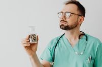 Kaboompics - Doctor Examining Clear Medicine Bottle