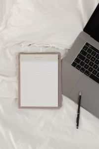 Kaboompics - Minimal Work From Bed Setup with Laptop and Blank Notepad
