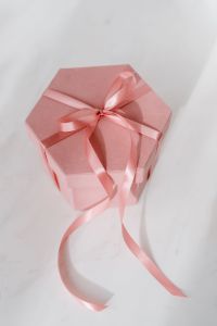 Kaboompics - Light pink velvety box with satin ribbon on white marble