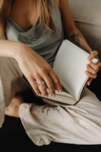 Kaboompics - Woman Holding an Open Book While Relaxing at Home