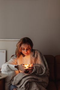 Kaboompics - Woman Holding a Candle During a Cozy Evening at Home