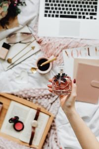 Kaboompics - Coffee, Cosmetics and Laptop with Hand-Held Perfume Flat Lay