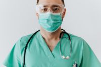 Kaboompics - Doctor in Protective Goggles and Surgical Mask with Stethoscope, Close-Up Patient Care Portrait