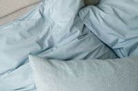 Kaboompics - Rumpled Soft Blue Bedding Minimal Bedroom Background
