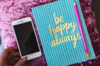 Kaboompics - Blue notebook with a pink iPhone and a pencil
