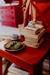 Kaboompics - Coffee, Green Tea Cookies, Books on the Red Chair