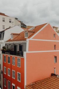 Kaboompics - Peach Lisbon Apartment Side Facade with Terracotta Rooftops and Dormer Windows
