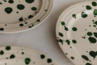 Kaboompics - Close-Up of Green Splatter Plates with Neutral Linen Copy Space