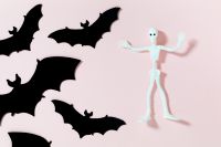 Kaboompics - Skeleton and Black Bats on Pink Background