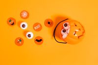 Kaboompics - Halloween Eyeball Candy and Pumpkin Flat Lay